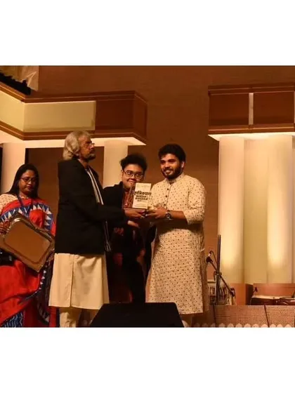 Receiving an award after performing at the West Bengal State Music Academy's Annual Festival. It was a wonderful experience playing in an open-air venue for a full house of music lovers.