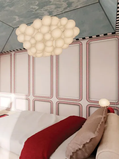 The wardrobe doors are designed with a red and white pattern, echoing the room's color scheme and adding to its graphic quality.