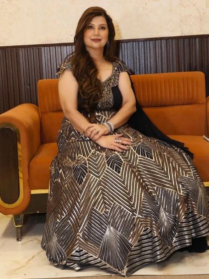 A seated portrait of my client in her black and silver gown. The outfit looks just as stunning when seated, showing the quality of the fabric and fit.