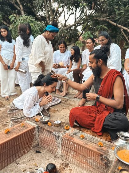 A student receives a tilak on her forehead during a ceremony. This sacred mark on the third eye point is a blessing and a reminder to see the world with wisdom and intuition.