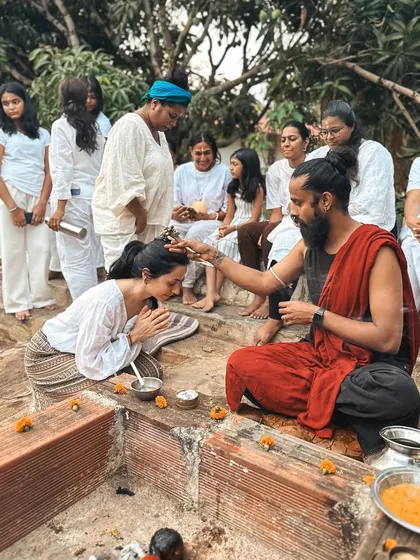 A student receives a blessing during an outdoor ceremony. These rituals connect us to the ancient traditions of yoga and mark important moments in our spiritual journey.