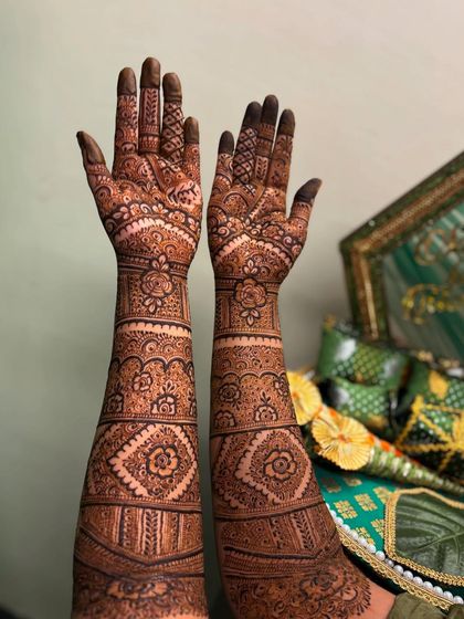 A beautiful and intricate Pakistani bridal design with repeating geometric and floral bands. This style is perfect for brides who want a very full and traditional look.