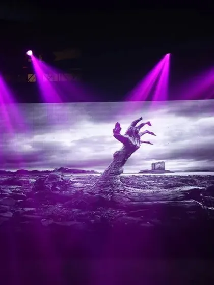An example of how I use large LED screens and dramatic lighting to enhance a theme. This spooky hand graphic with purple spotlights created a powerful focal point for a Halloween event.