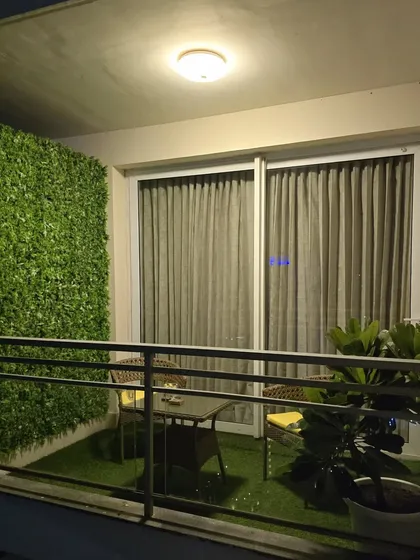 Even a small apartment balcony can become your personal green oasis. I installed soft artificial grass on the floor and a dense green panel on the wall to create this cozy, private corner. Perfect for your morning chai or evening relaxing.