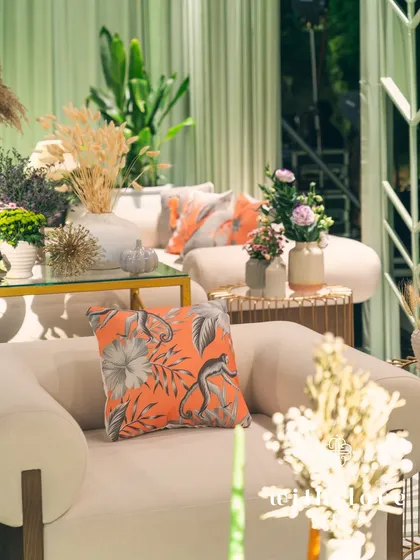 A lounge area in 'The Conservatory', with a custom cushion adding a pop of color.