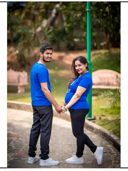 A casual and sweet photo of a couple holding hands and looking back at the camera.