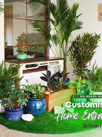 A welcoming home starts at the entrance. We transformed this stilt area into a lush and inviting entryway using a layered arrangement of real plants in varied ceramic pots, set on a bed of artificial turf for a clean, evergreen look.