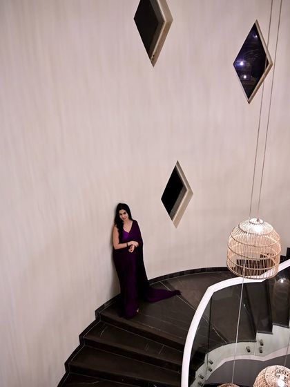 A wide shot showing the full spiral staircase, emphasizing the dramatic and architectural nature of the shoot.