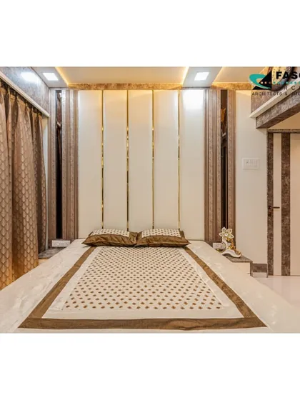 A compact bedroom in Bhiwandi where space is maximized through design. A tall, paneled headboard with vertical mirror strips draws the eye upward, making the room feel taller.