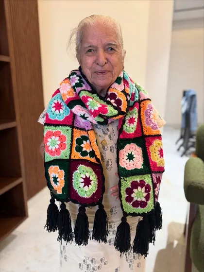 A variation of our floral granny square muffler, this one features a different flower pattern in each square. The rich, jewel-toned colors make it a luxurious and eye-catching accessory.