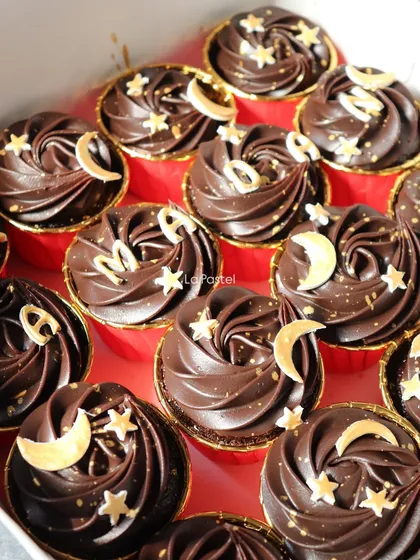 The full box of Ramadan cupcakes, spelling out the festive greeting with rich chocolate and gold details.