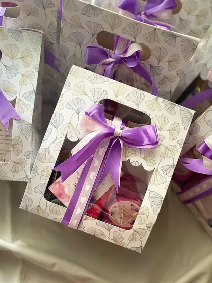 Announcing the arrival of a baby girl with our cute mini hampers. Each bag is filled with sweet treats and tied with a purple ribbon to share the joy.