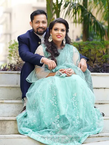 A beautiful formal portrait of the engaged couple. Their coordinated outfits and happy smiles make for a perfect picture.