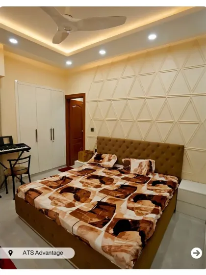 This bedroom uses geometric wall molding in a triangular pattern to create a subtle yet stylish accent wall. The design is clean, modern, and elegant.