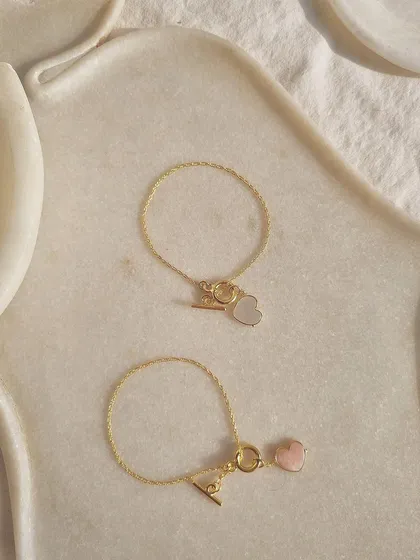 My heart toggle bracelets in pink opal and white moonstone, designed to be tokens of love and peace.