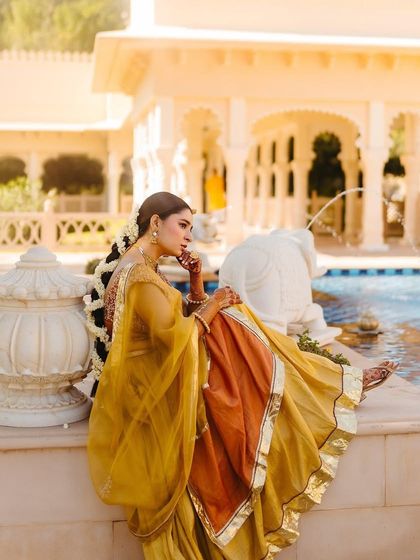 A side profile of Shree's Haldi look, showing her braided hairstyle adorned with fresh mogra flowers, a nod to South Indian tradition.