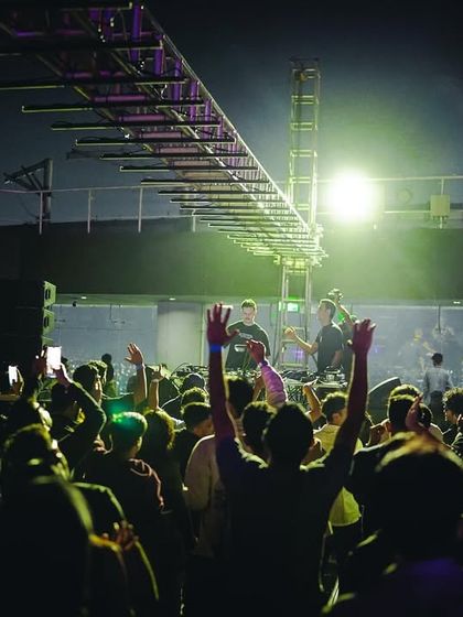 The crowd raises their hands in unison during a set at High Ultra Lounge. This is the kind of collective energy I strive to create every weekend.