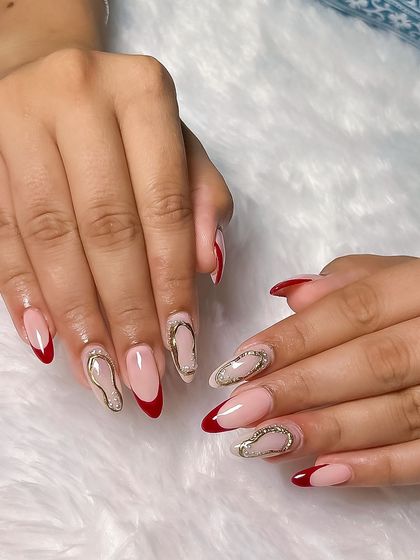 A bold and stylish set featuring a red French tip and intricate gold chrome designs. This student work showcases their command of multiple advanced techniques.