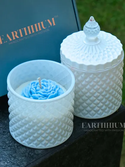 Elegance poured into glass. This floral jar candle features a beautiful blue rose nestled in a white diamond-textured jar with a matching lid to keep the scent fresh.