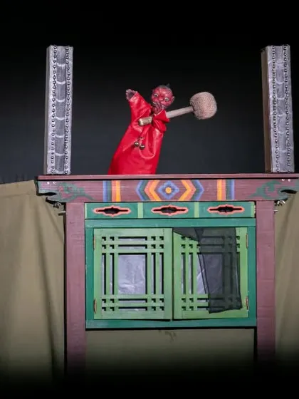 A fearsome red puppet character from 'Hong Dongji & Isimi'. The show tells the story of a mischievous hero who must defeat a monster and a corrupt magistrate.