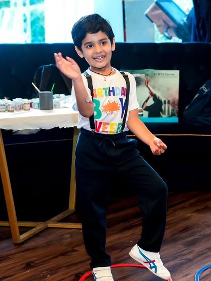 The birthday boy, Veer, enjoying his art-themed party. I organize various activities, including games like ring toss, to keep the creative energy flowing.