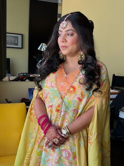 The client looks beautiful and festive with her unique and colorful hairstyle.