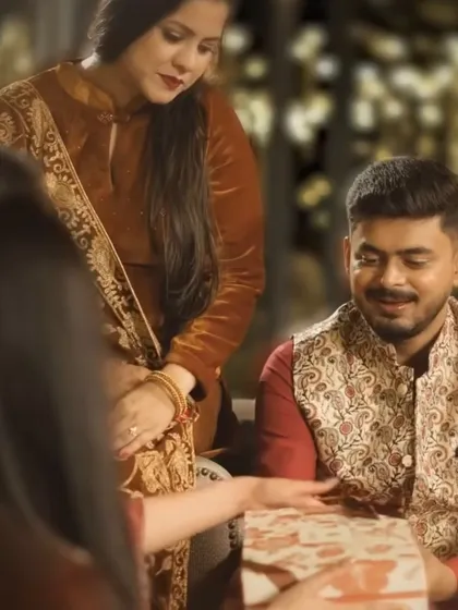 A quiet moment during a festive gathering. The warm lighting and traditional attire showcase the suitability of the space for family events like Diwali or Sagan ceremonies.