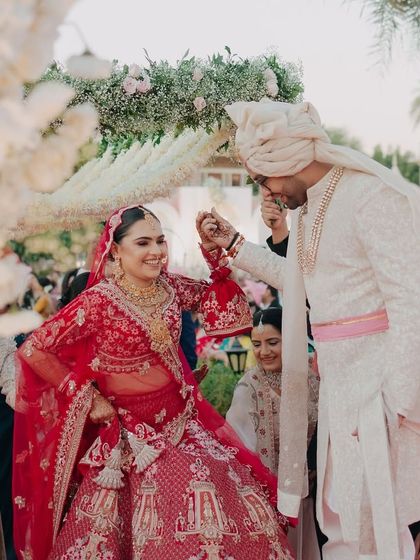A playful and candid moment during the wedding rituals, capturing the genuine connection and happiness between the bride and groom.