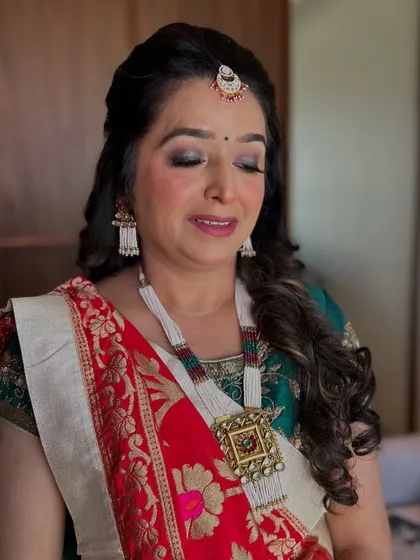 A classic look for the mother of the bride. The makeup is elegant and timeless, with a soft smokey eye and a traditional bindi.