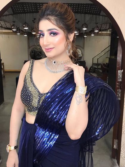 A bold and glamorous party look featuring dramatic purple eyeshadow and a chic updo.