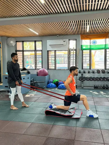 Guiding an athlete through a mobility exercise. Proper coaching ensures the movement is performed correctly, targeting the right muscles and preventing compensation patterns that could lead to injury.