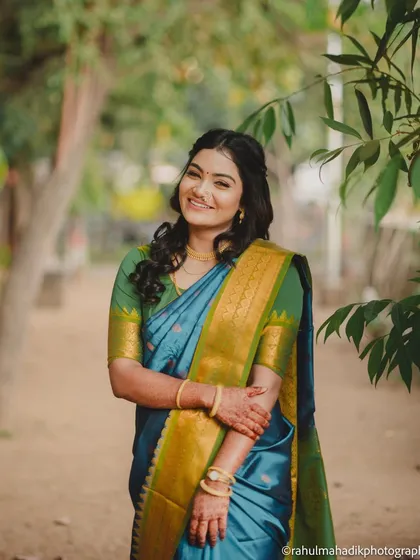 A bright and happy portrait of the bride in a natural, outdoor setting. Her radiant smile and relaxed pose make for a beautiful and welcoming image.