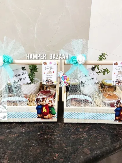 An Alvin and the Chipmunks themed hamper for a first birthday, featuring a pinewood crate and four jars of treats.