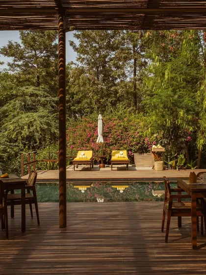 Another perspective from the pavilion, showcasing the inviting pool and the tranquil forest backdrop.