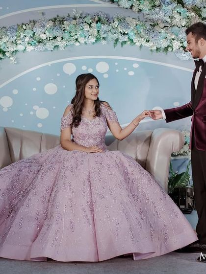 A wide shot showing the stunning engagement gown in all its glory against the beautiful floral backdrop.