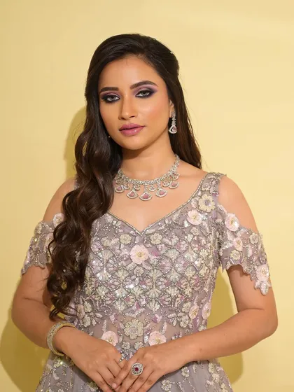 A portrait showcasing the full sangeet look. The bride looks like a modern princess, with her makeup perfectly complementing the ethereal gown.