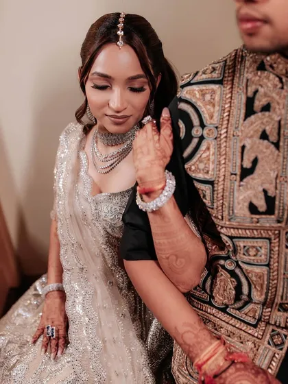 A tender moment between the couple. The bride's soft glam makeup looks beautiful and romantic, perfect for these intimate shots.