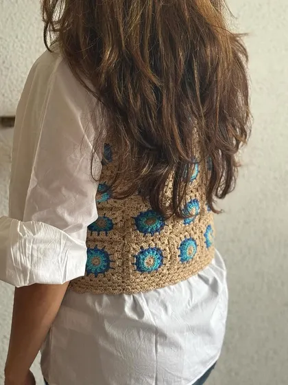 The back view of the granny square vest. The pattern is consistent all the way around, ensuring the piece looks great from every angle.
