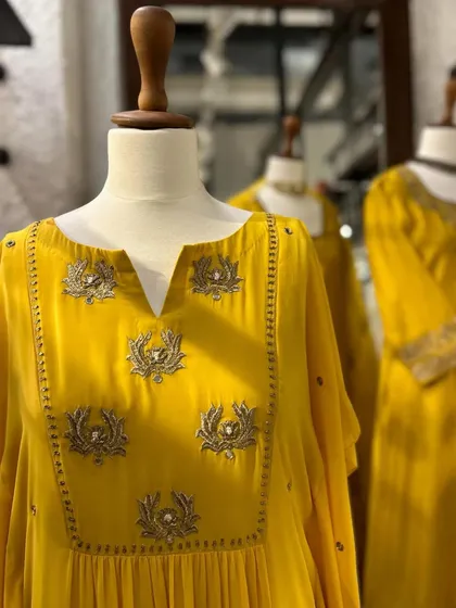 A detailed shot of a yellow kurta with delicate silver lotus-motif embroidery, perfect for a festive occasion.