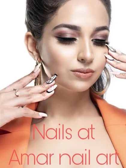 A professional shot of a model wearing my custom nail art. This set features a mix of white and black nails with graphic, abstract line art for a high-fashion look.