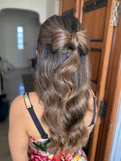 A side view of the hair bow, a unique and playful choice for a brunch or day party.