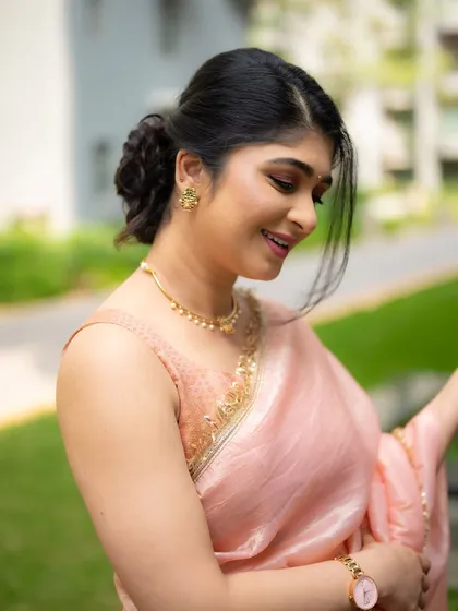 A profile shot of actress Aditi Prabhudeva in a delicate peach saree. The soft lighting and her elegant posture create a classic and graceful portrait.