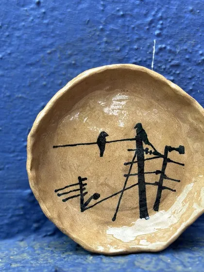 This small, rustic plate is part of my series inspired by the crows of Mumbai. The simple, almost sketch-like quality of the painting is intentional, reflecting a fleeting moment observed from my window.