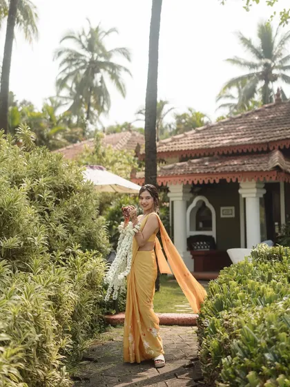A bride in a simple yellow saree for her Haldi ceremony at the Taj Holiday Village, Goa. The look is traditional, elegant, and perfectly suited for the lush, tropical surroundings.