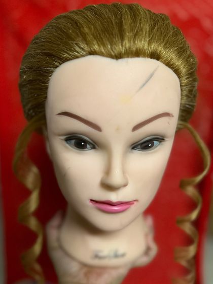 An example of a basic practice drill, creating simple face-framing curls. Mastering these small details is a key part of the learning process in my hair education program.