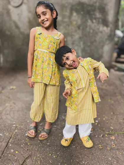 A playful pose from this adorable brother-sister duo in their matching yellow outfits. I love seeing my creations become a part of their happy moments.