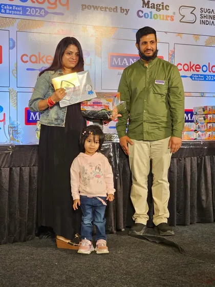 On stage with my daughter and one of the event organizers, receiving my prize.