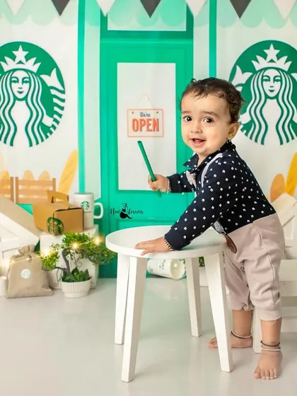 This dapper little barista is standing proud at his coffee counter. Themed shoots like this are a great way to capture your child's budding personality.
