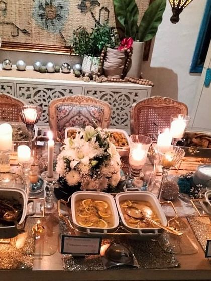 A cozy and festive Christmas party spread, complete with candles and floral arrangements. The menu featured hearty dishes like spicy rigatoni and grilled sole, perfect for a winter celebration.