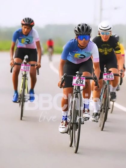 A female rider from the Racefit Coaching team, showing her strength and determination.